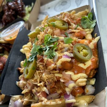 Rick's Good Eats - Signature butter chicken fries - Indian Near Me - Mississauga, Ontario