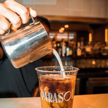 Parasol Cafe - a person pouring coffee into a cup - Coffee & Tea Near Me - Miami Beach, Florida Parasol Cafe - a person pouring coffee into a cup - Coffee & Tea Near Me - Miami Beach, Florida