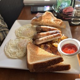 Eggs over easy, apple smoked sausage, hash browns, and white toast.