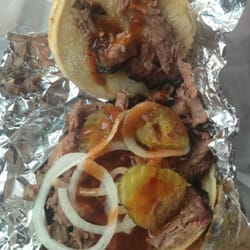 Brooks' Place - Chopped beef brisket sandwich. They give you a small container of sauce and small bags of pickles and onions on the side.