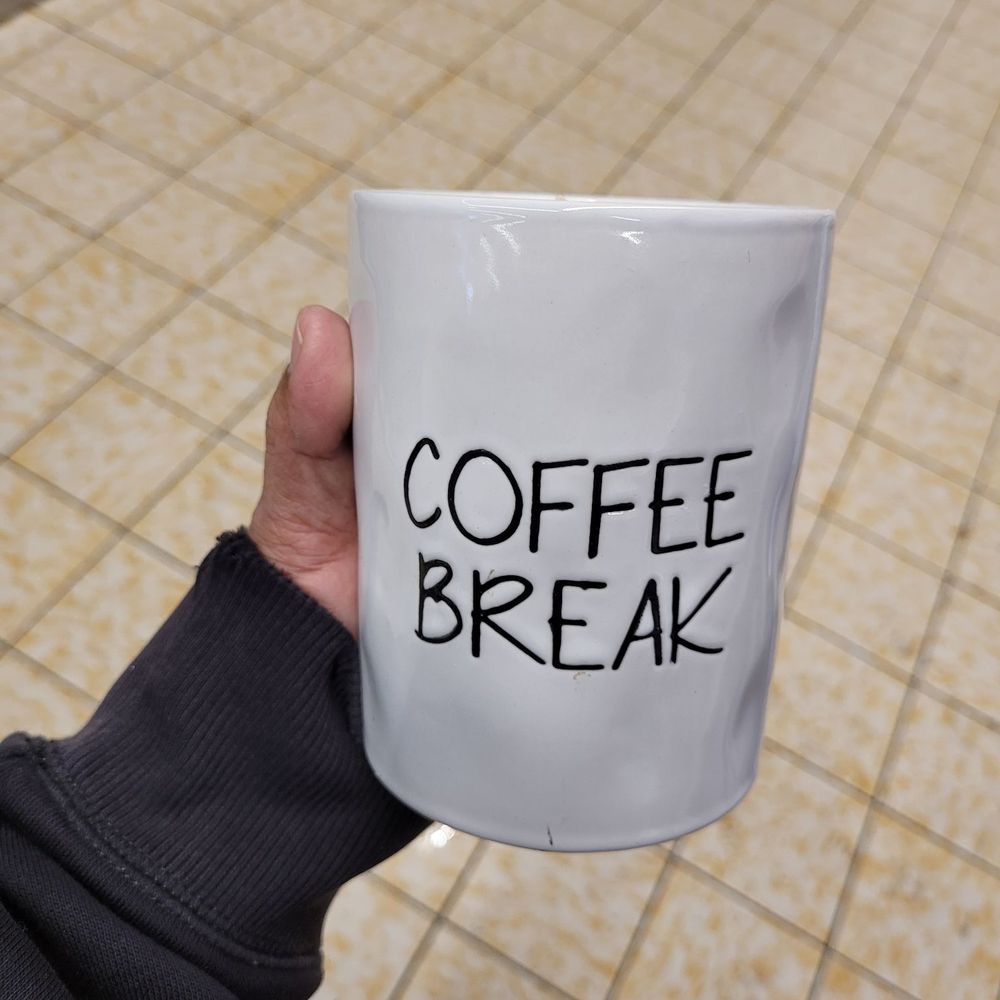 ALDI - a person holding a coffee mug with coffee break written on it - Grocery Near Me - Chicago, Illinois