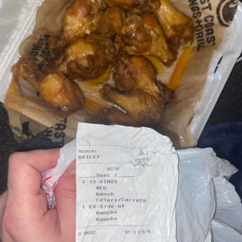 East Coast Wings + Grill - a hand holding a receipt - American Near Me - Charlotte, North Carolina East Coast Wings + Grill - a hand holding a receipt - American Near Me - Charlotte, North Carolina