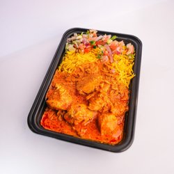 Halal Butter Chicken Platter with aromatic basmati rice and fresh chopped salad at Parathas & Platters Englewood.