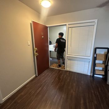 Optimuv Moving - Workers moving furniture in the house - Movers Near Me