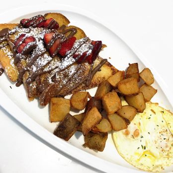 Omelet Bar - Nutella and strawberry French toast w breakfast potatoes and eggs over easy. Delicious. - Breakfast & Brunch Near Me - Orlando, Florida