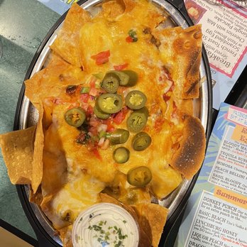 Brass Balls Saloon - $12.99 | Super Nachos - beef, shredded cheddar Jack cheese, salsa, queso, pico, & jalapeños. Comes w/ sour cream. Fresh guac is $3.99 - Bars Near Me - Ocean City, Maryland
