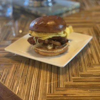 NBHD - Turkey sausage sandwich on a brioche bun with caramelized onions. - Coffee & Tea Near Me - New York, New York NBHD - Turkey sausage sandwich on a brioche bun with caramelized onions. - Coffee & Tea Near Me - New York, New York