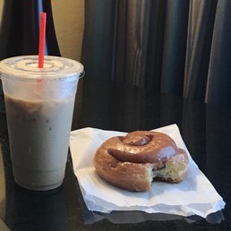 Large vanilla iced coffee and cinnamon roll donut