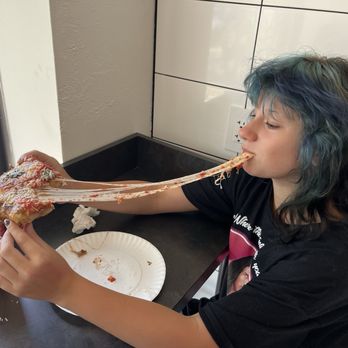 Rockaway Pizzeria - Grandma pie slice with correlating blue hair effect - Pizza Near Me - Pittsburgh, Pennsylvania