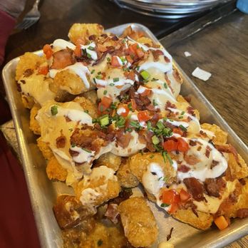 Drafts Burger Bar - Tatter Tots with cheese, bacon, sour cream and sprinkles of tomatoes. - American Near Me - Park City, Utah