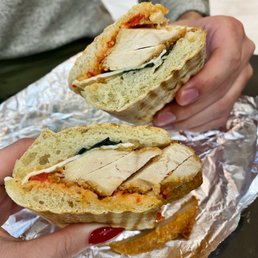 a person holding a sandwich a person holding a sandwich