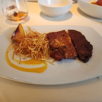 BCN Taste & Tradition - Suckling Ibérico pig "a la Segoviana", shoestring fries, and peach in textures - Catalan Near Me - Houston, Texas BCN Taste & Tradition - Suckling Ibérico pig "a la Segoviana", shoestring fries, and peach in textures - Catalan Near Me - Houston, Texas