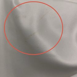 Stain on the chest area of gown.