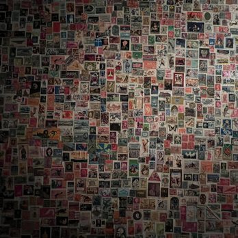 Cafe Rue Dix - Bathroom covered in stamps! - French Near Me - Brooklyn, New York
