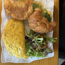 Croissant breakfast sandwich, hash brows, house salad, and a london fog
