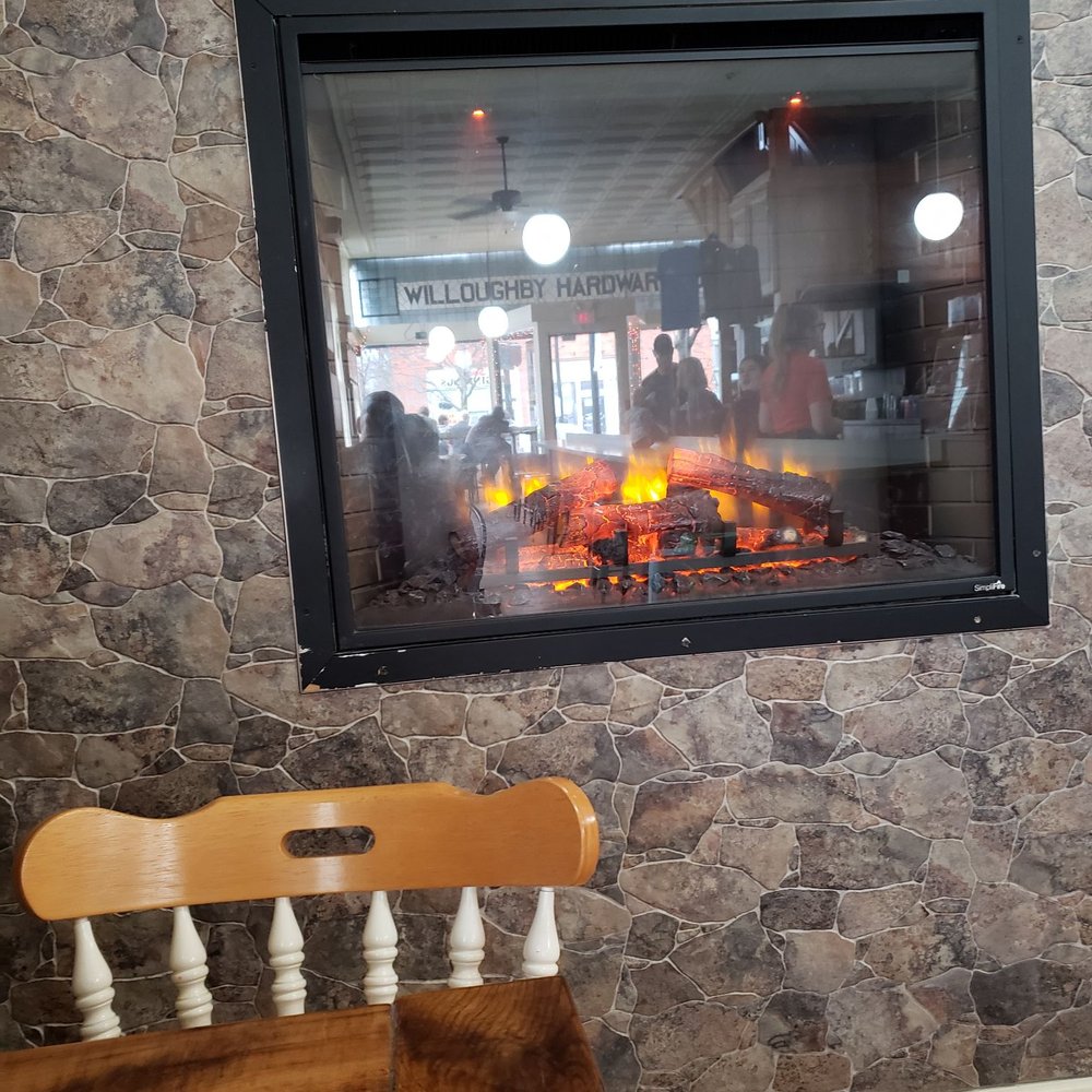 Fionas Coffee Bar And Bakery - Electric fireplace and table and chairs to enjoy your warm beverage - Bagels Near Me - Willoughby, Ohio