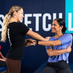 Relieve mid-back pain and improve thoracic mobility with a 1-on-1 assisted seated twist stretch at StretchLab.