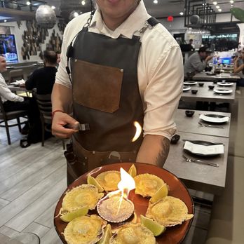 Naori - Scallops flaming with melted cheese - Japanese Near Me - Sunrise, Florida Naori - Scallops flaming with melted cheese - Japanese Near Me - Sunrise, Florida