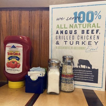Islands Restaurant - Location of the menu along with the condiments and seasonings offered at each table. - Burgers Near Me - Manhattan Beach, California