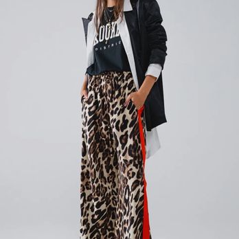 Market 31 Boutique - These bold leopard print pants with a striking red stripe along the sides are designed for those who love to make a statement. - Women's Clothing Near Me - Keller, Texas Market 31 Boutique - These bold leopard print pants with a striking red stripe along the sides are designed for those who love to make a statement. - Women's Clothing Near Me - Keller, Texas
