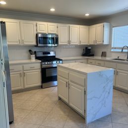 Quartz countertop and repainted kitchen cabinets along with installed new handles Quartz countertop and repainted kitchen cabinets along with installed new handles