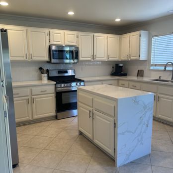 Decor CJ's Painting - Quartz countertop and repainted kitchen cabinets along with installed new handles - Painters Near Me