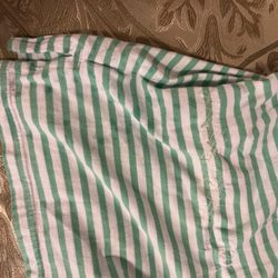 Top Cleaners - Shirt is longer in back and should have been repaired with simple fold and seam in parallel to lines.