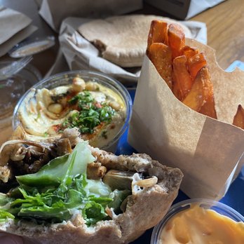 Shouk - Mushroom shawarma in pita, sweet potato fries, hummus and pita, harrisa mayo - Vegan Near Me - Rockville, Maryland