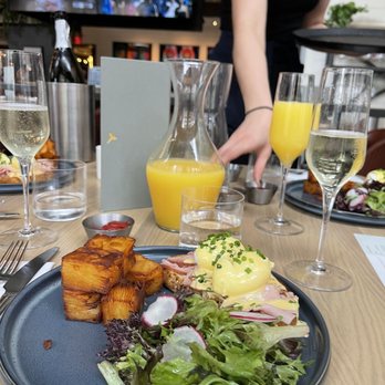 Earls Kitchen + Bar - Eggs Benedict with Happy hour Mimosa - Canadian (New) Near Me - Vancouver, British Columbia Earls Kitchen + Bar - Eggs Benedict with Happy hour Mimosa - Canadian (New) Near Me - Vancouver, British Columbia