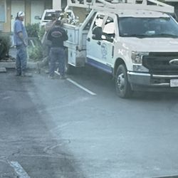 Bradley & Sons Water Well Drilling & Pump Systems - Employees drinking in a hotel parking lot.