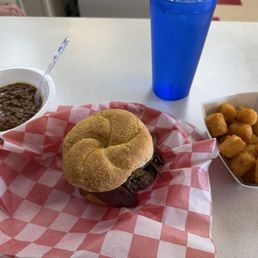 Char burger Spanish style, crispy tots and a side of chili