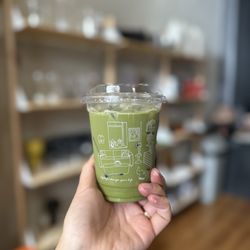 6XS STUDIO - Iced matcha latte with oat milk (look at that color!). Artisan wares for purchase in the background.