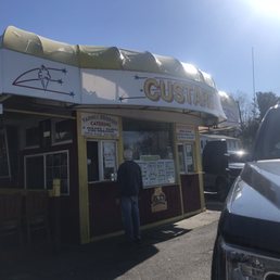 a man standing in front of a restaurant a man standing in front of a restaurant