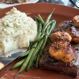 Sirloin steak, scallops, mashed potatoes, French green beans. Sirloin steak, scallops, mashed potatoes, French green beans.