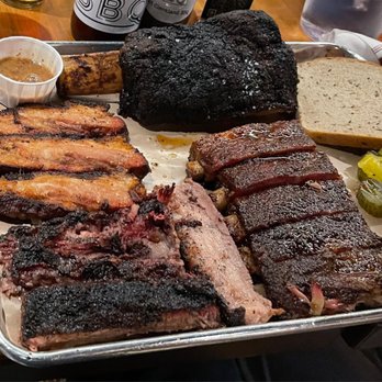 Mabel's BBQ - Beef rib, pork ribs, brisket, and pork belly clockwise. - Barbeque Near Me - Cleveland, Ohio