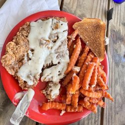 Mill Creek Cafe - Half of the serving of chicken fried steak with sweet potato fries.