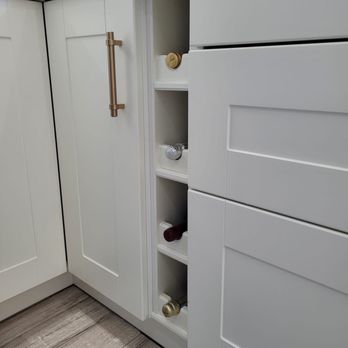 Kaspro Home - a kitchen with white cabinets and marble countertops - General Contractors Near Me Kaspro Home - a kitchen with white cabinets and marble countertops - General Contractors Near Me