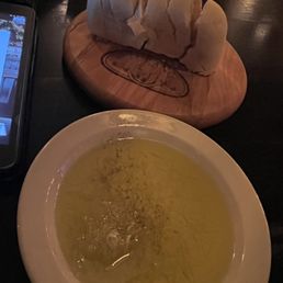 a bowl of soup and a cell phone a bowl of soup and a cell phone