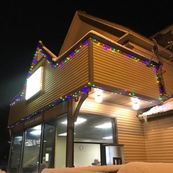 Fire 21 - the outside of a building decorated with christmas lights - Pizza Near Me - Conway, New Hampshire