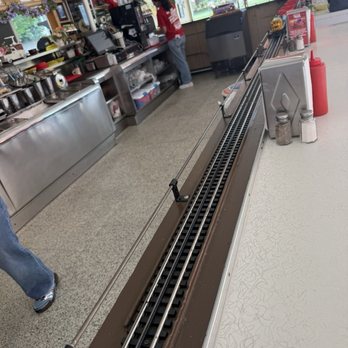 Choo Choo Restaurant - Train running from the kitchen around the counter delivering food. - Burgers Near Me - Des Plaines, Illinois Choo Choo Restaurant - Train running from the kitchen around the counter delivering food. - Burgers Near Me - Des Plaines, Illinois