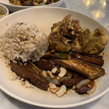 Flower Child - A plate with spicy eggplant, brown rice, and spices cauliflower. - Salad Near Me - Houston, Texas
