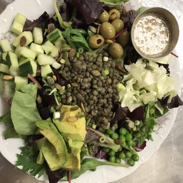 Mean greens salad out of this world! Lentils, peas, avocado, cucumber,olives, pumpkin seeds,sesame ginger dressing etc..