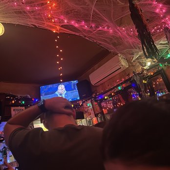 Biddy's Pub - a man playing a video game - Pubs Near Me - New York, New York