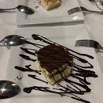 Limoncello Ristorante - Tiramisu (lower) and almond cake (upper) - Italian Near Me - Boston, Massachusetts Limoncello Ristorante - Tiramisu (lower) and almond cake (upper) - Italian Near Me - Boston, Massachusetts