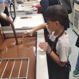 dipping the pretzel stick into the chocolate dipping the pretzel stick into the chocolate