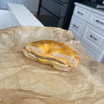 Schmagel's Bagels - Half eaten (couldn't wait) cheddar-Jack bagel with sausage, egg, and cheddar garlic cream cheese. - Bagels Near Me - Saint Augustine, Florida Schmagel's Bagels - Half eaten (couldn't wait) cheddar-Jack bagel with sausage, egg, and cheddar garlic cream cheese. - Bagels Near Me - Saint Augustine, Florida
