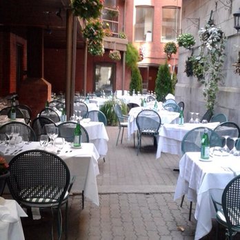 Il Cortile - an outdoor dining area with tables and chairs - Italian Near Me - Montreal, Quebec