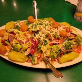 Oregano's - a plate of salad on a table - Pizza Near Me - Tempe, Arizona Oregano's - a plate of salad on a table - Pizza Near Me - Tempe, Arizona