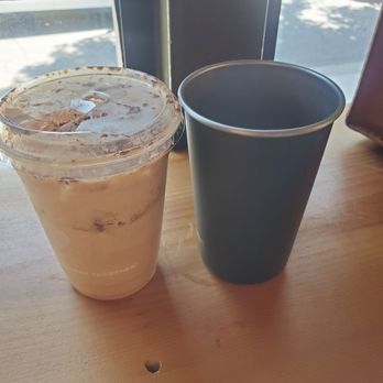 Dripp - My iced Spanish latte in a plastic cup and my perfectly usable steel cup that was ready to be of service. - Coffee & Tea Near Me - Fullerton, California
