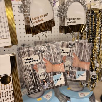 Five Below - Headbands with 'happy new year' message and fringe backdrop photo props in packaging are displayed on a store peg. - Discount Store Near Me - Mayfield Heights, Ohio